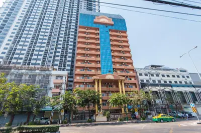 a tall building with cars parked in front of it at King Royal 2 in Bangkok