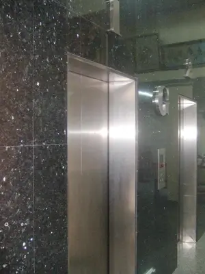 an elevator in a building with a glass wall at Lodge 61 Hotel in Bangkok