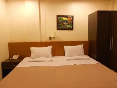 a hotel room with a bed with a phone on it at Lodge 61 Hotel in Bangkok