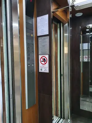 a elevator with signs on the side of a building at The Montana Lodge-Sathorn in Bangkok