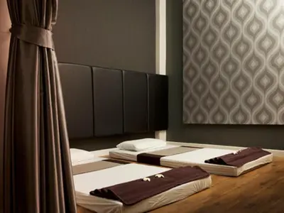 two beds in a room with a mirror at Siam Swana in Bangkok
