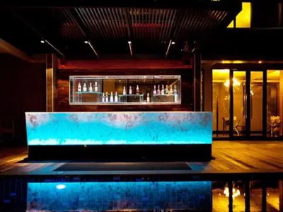 a bar in the middle of a room at Siam Swana in Bangkok