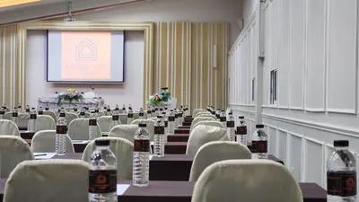 a conference room with chairs and bottles of wine at Brighton Hotel Bangkok in Bangna