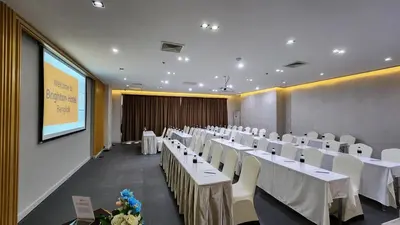 a conference room with white tables and white chairs at Brighton Hotel Bangkok in Bangna