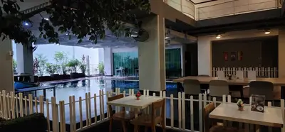 a restaurant with a pool in the middle of the room at Brighton Hotel Bangkok in Bangna