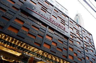 a building with lights on the side of it at FuramaXclusive Pratunam Park Hotel in Bangkok