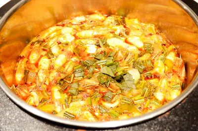 a pot of food with shrimp and vegetables in it at FuramaXclusive Pratunam Park Hotel in Bangkok
