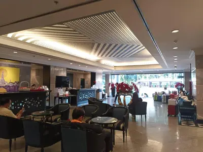 a lobby with people sitting in chairs and tables at Witz Bangkok Ramkhamhaeng in Bangkok