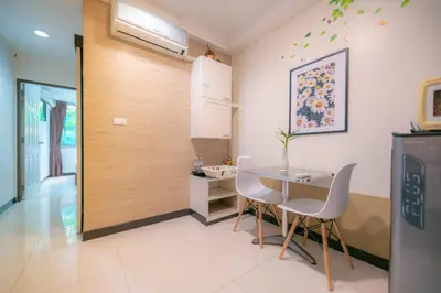 a dining room with a table and chairs at Baan Sabai Rama IV Apartment in Bangkok
