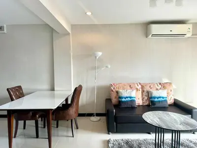 a living room with a couch and a table at Baan Sabai Rama IV Apartment in Bangkok