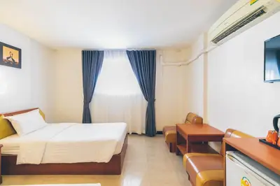 a hotel room with a bed and a window at Atlas Bangkok Hotel in Bangkok
