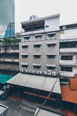 an external view of a building with a roof at Atlas Bangkok Hotel in Bangkok