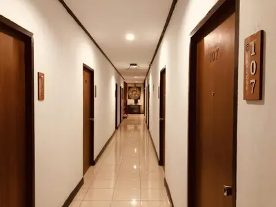 a corridor of a hospital hallway with doors and tiles at At Bangkok Hotel in Bangkok