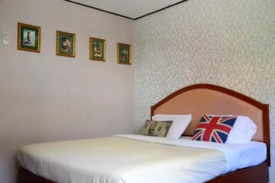a bedroom with a bed with a white bedspread at At Bangkok Hotel in Bangkok