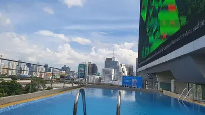 a large swimming pool on the side of a building at Interchange Tower Serviced Apartment - SHA Extra Plus in Bangkok