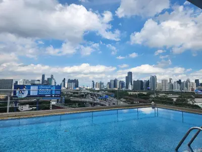 a swimming pool with a view of the city at Interchange Tower Serviced Apartment - SHA Extra Plus in Bangkok