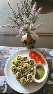 a plate with eggs and tomatoes on a table with a vase at Interchange Tower Serviced Apartment - SHA Extra Plus in Bangkok