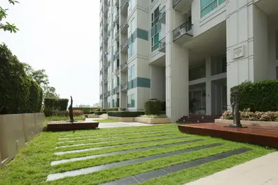 a grassy yard in front of a building at Ivy Thonglor 55 in Bangkok