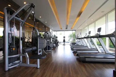 a gym with rows of treadmills and machines at Ivy Thonglor 55 in Bangkok