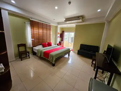 a bedroom with a bed and a tv in a room at Royal Pimand Hotel in Bangkok
