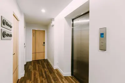 a hallway with a elevator and a door at Metro hotel in Bangkok