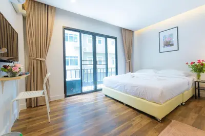 a bedroom with a bed and a large window at Metro hotel in Bangkok