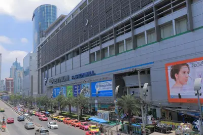 a busy city street with cars parked in front of a building at The Konnect Hotel in Bangkok