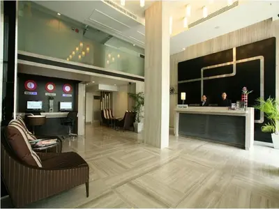 a lobby with people sitting at a reception desk at FX Hotel Metrolink Makkasan in Bangkok