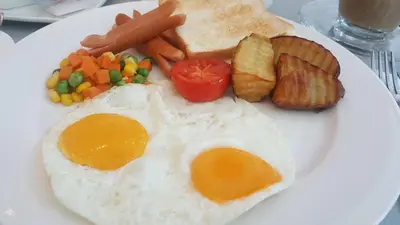 a plate of breakfast food with eggs and toast at The Kinn Bangkok in Bangkok