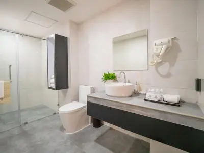 a bathroom with a sink and a toilet at The Kinn Bangkok in Bangkok