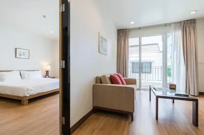 a bedroom with a bed and a couch and a table at Bangkok Patio BTS Sanam Pao in Bangkok