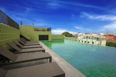 a swimming pool on the side of a building at Chillax Heritage Hotel Khaosan in Bangkok