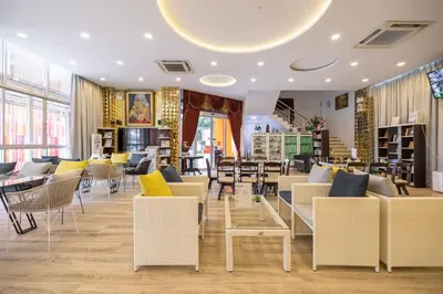 a restaurant with chairs and tables in a room at Bangkok Rama Hotel in Bangkok