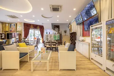a store with chairs and a table in a room at Bangkok Rama Hotel in Bangkok