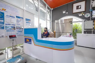 a woman is sitting in a booth at a exhibit at Bangkok Rama Hotel in Bangkok