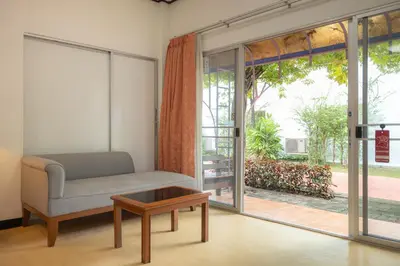 a living room with a couch and a table at Bangkok Rama Hotel in Bangkok