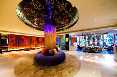 a lobby with a large art installation in the ceiling at Tongtara Riverview Hotel in Bangkok