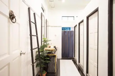 a hallway with a door and a plant at The Orientale Hostel in Bangkok