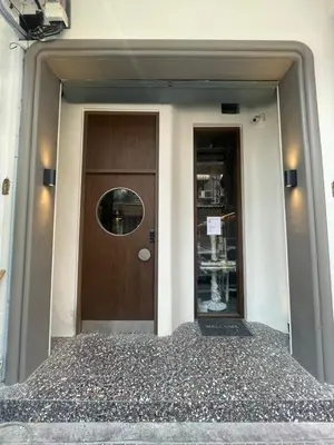 a front door of a building with a brown door at The Orientale Hostel in Bangkok