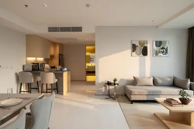 a living room with a couch and a table at Jasmine 59 Hotel in Bangkok