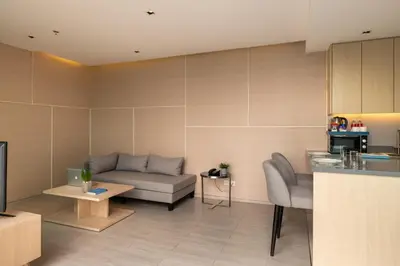 a living room with a couch and a table at Jasmine 59 Hotel in Bangkok