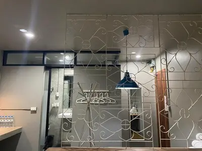 a room with a glass door with a wall at Yaksa Private in Bangkok