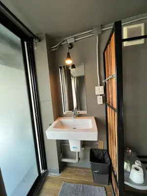 a bathroom with a sink and a mirror at Yaksa Private in Bangkok