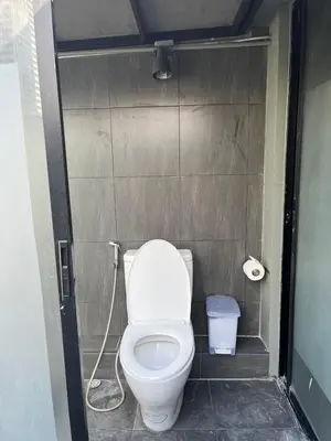 a small bathroom with a toilet in a stall at Yaksa Private in Bangkok