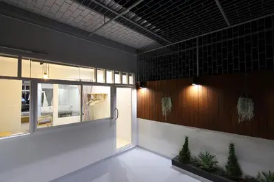 a room with a window and plants on the wall at Ekanake hostel in Bangkok