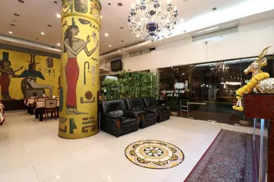 a lobby with a large column in a store at Diamond Residence Silom in Bangkok