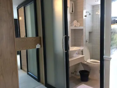 a bathroom with a toilet and a sink at Bourbon St. Boutique Hotel in Bangkok
