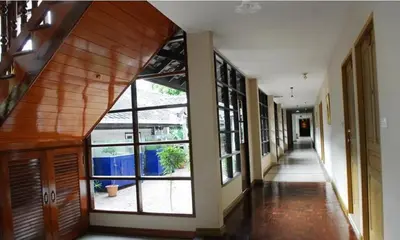 an empty hallway with large windows in a building at Silom Village Inn in Bangkok