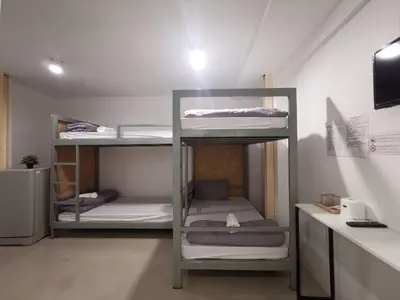 a room with three bunk beds in a room at Studio 41 Salaya-Sai4 in Nakhon Pathom