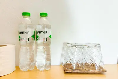 two bottles of water sitting on top of a table at Living Naraa Place in Bangkok